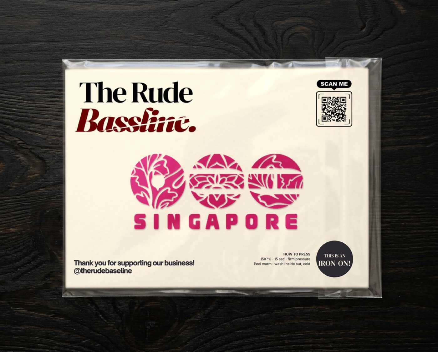 The magenta Singapore iron-on on a Rude Bassline backing card in a clear sleeve