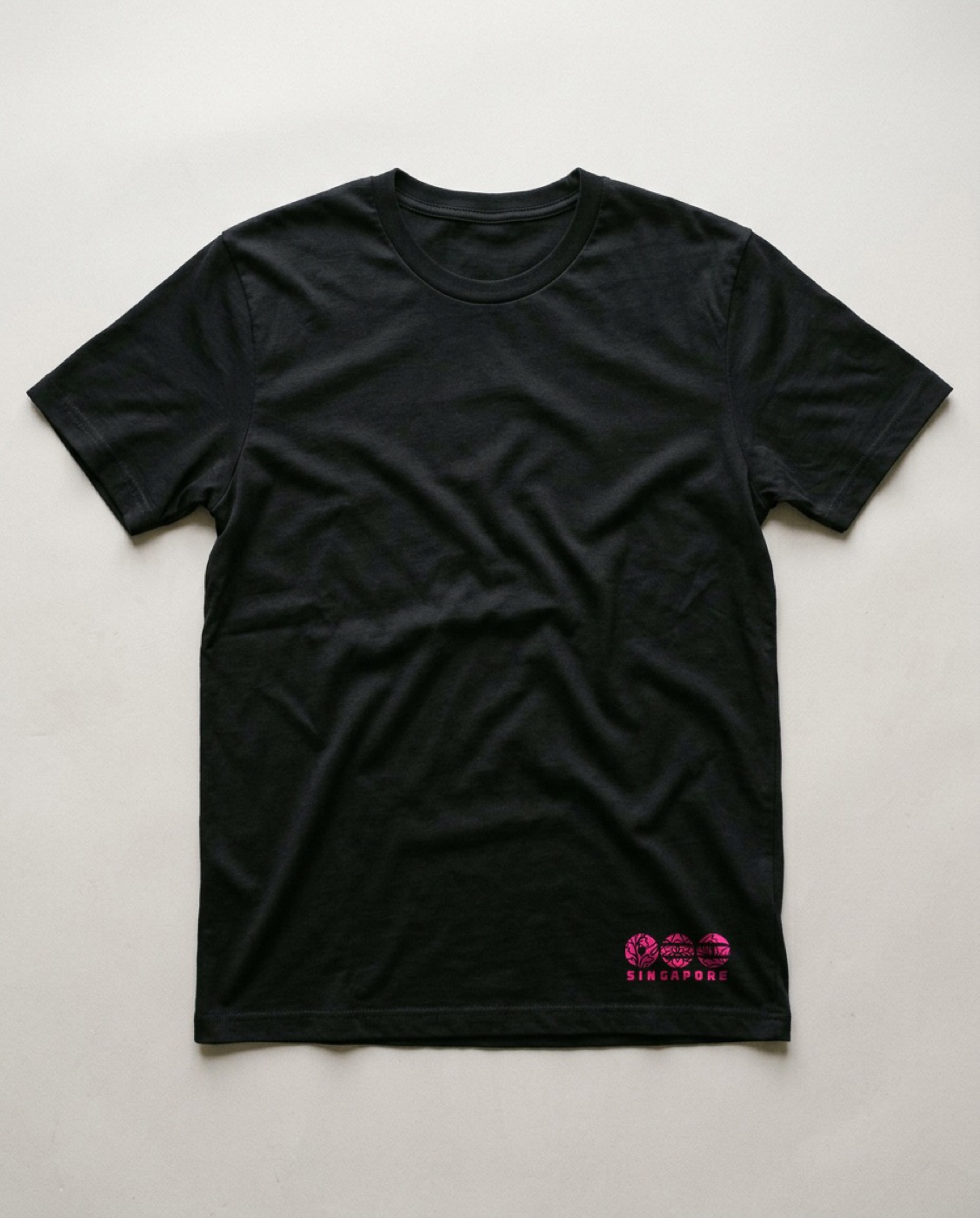 A black t-shirt with a small magenta Singapore heat transfer at the bottom right hem
