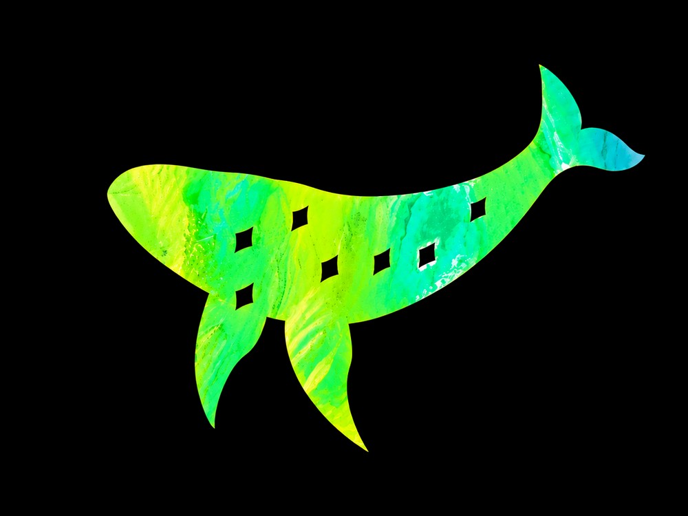 A green-blue holographic whale decal with diamond cutouts, cut and weeded, on black