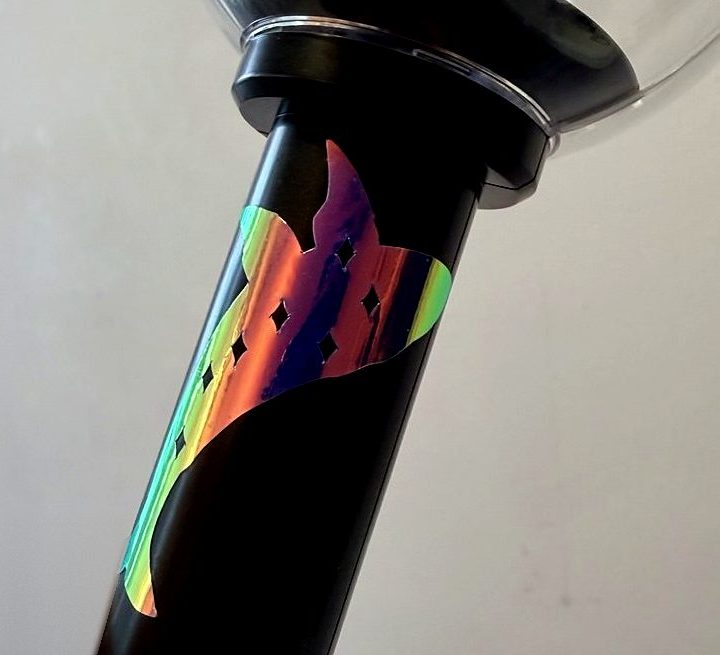 A holographic whale decal wrapped around the handle of an ARMY Bomb lightstick